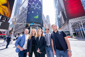 Members of the Lime team pose under sign reading “NASDAQ WELCOMES LIME FINANCIAL” 